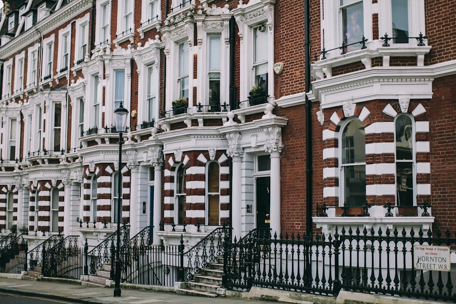 A row of Victorian terraced houses on Fulham Road, featuring ornate white and red facades with multiple sash windows and decorative architectural details. The image shows the front of the buildings fr